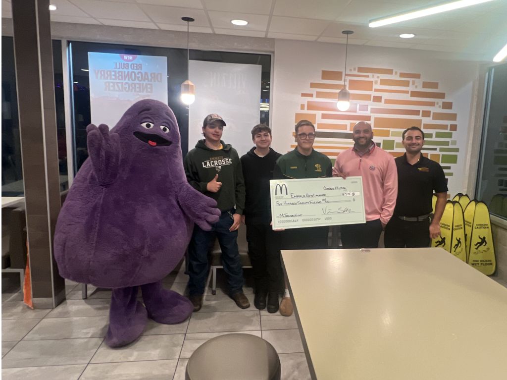 Owner Operator Vinay Shah presenting a check to the Emmaus Boys Lacrosse Booster Club