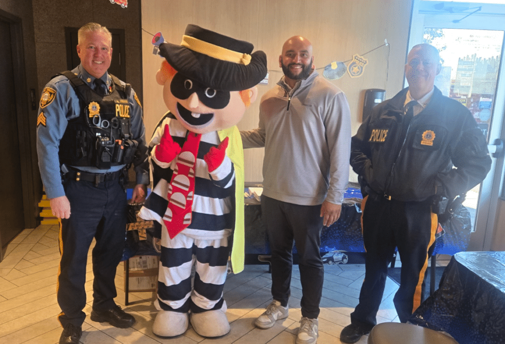 Owner Operator Vinay Shah posing with Hamburglar and Forks Township Police Officers